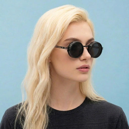 Woman wearing round sunglasses against a light blue background